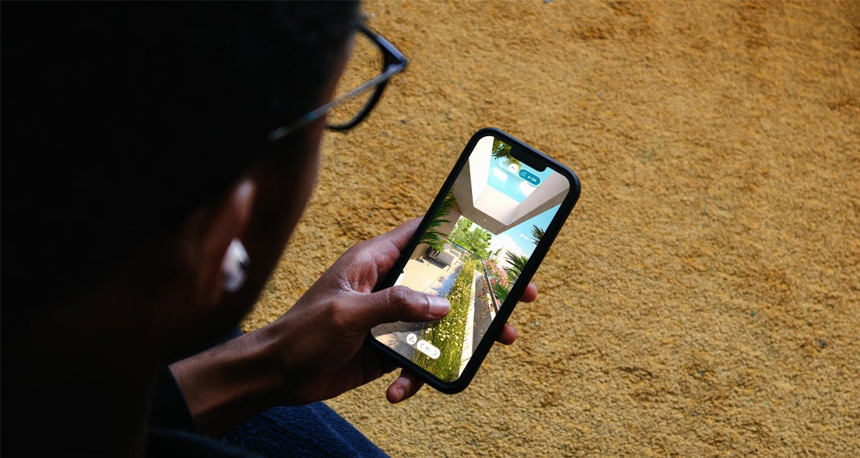 Man exploring an interactive 3D virtual tour of a residential development on a smartphone